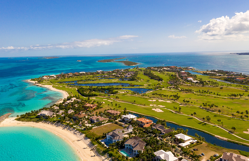 Aerial view of Albany Golf Club in the Bahamas, with fairways along turquoise water and white sand beaches