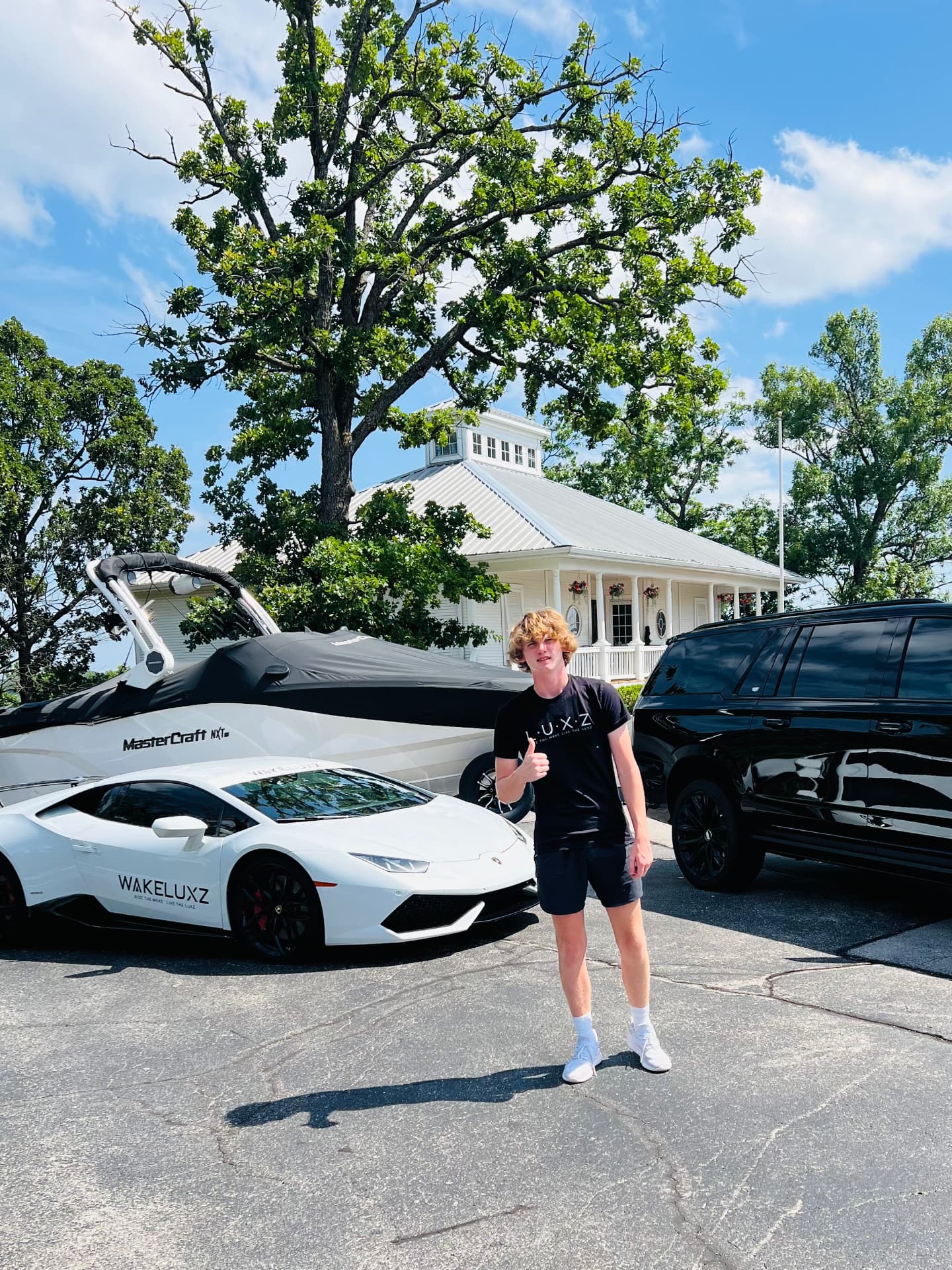 Collin with the WakeLuxz Lamborghini, the MasterCraft boat and the Escalade