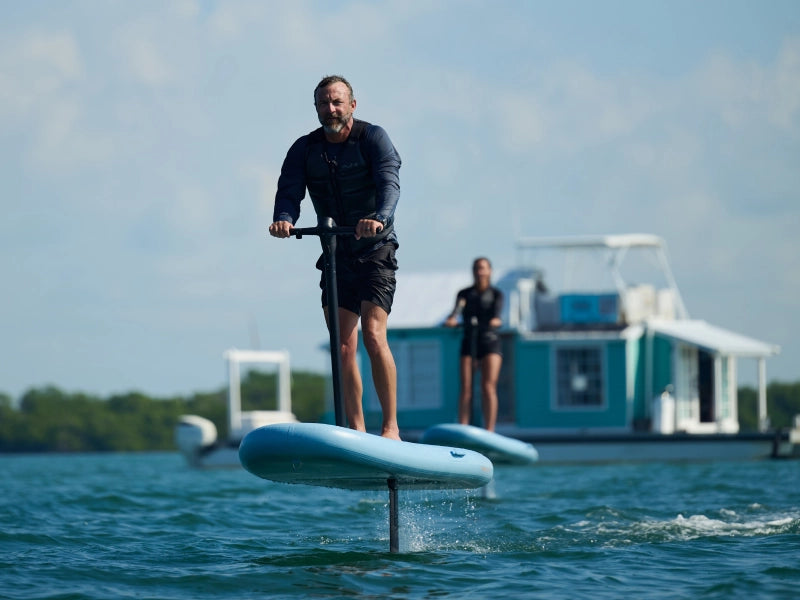 Fliteboard rider flying above open water