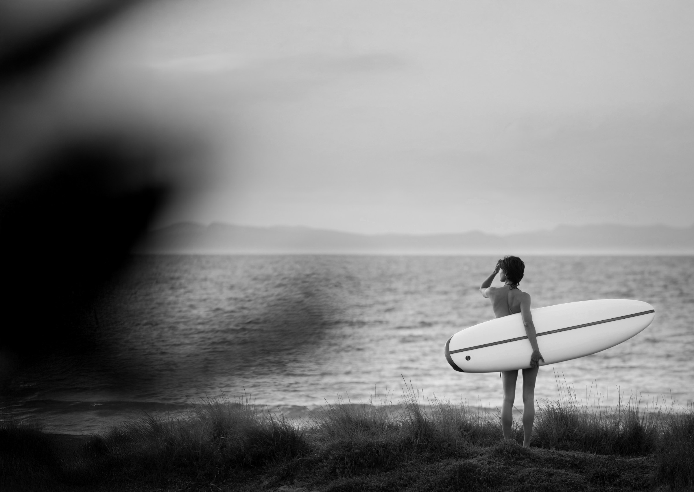 Rider on an electric surfboard carving across open water