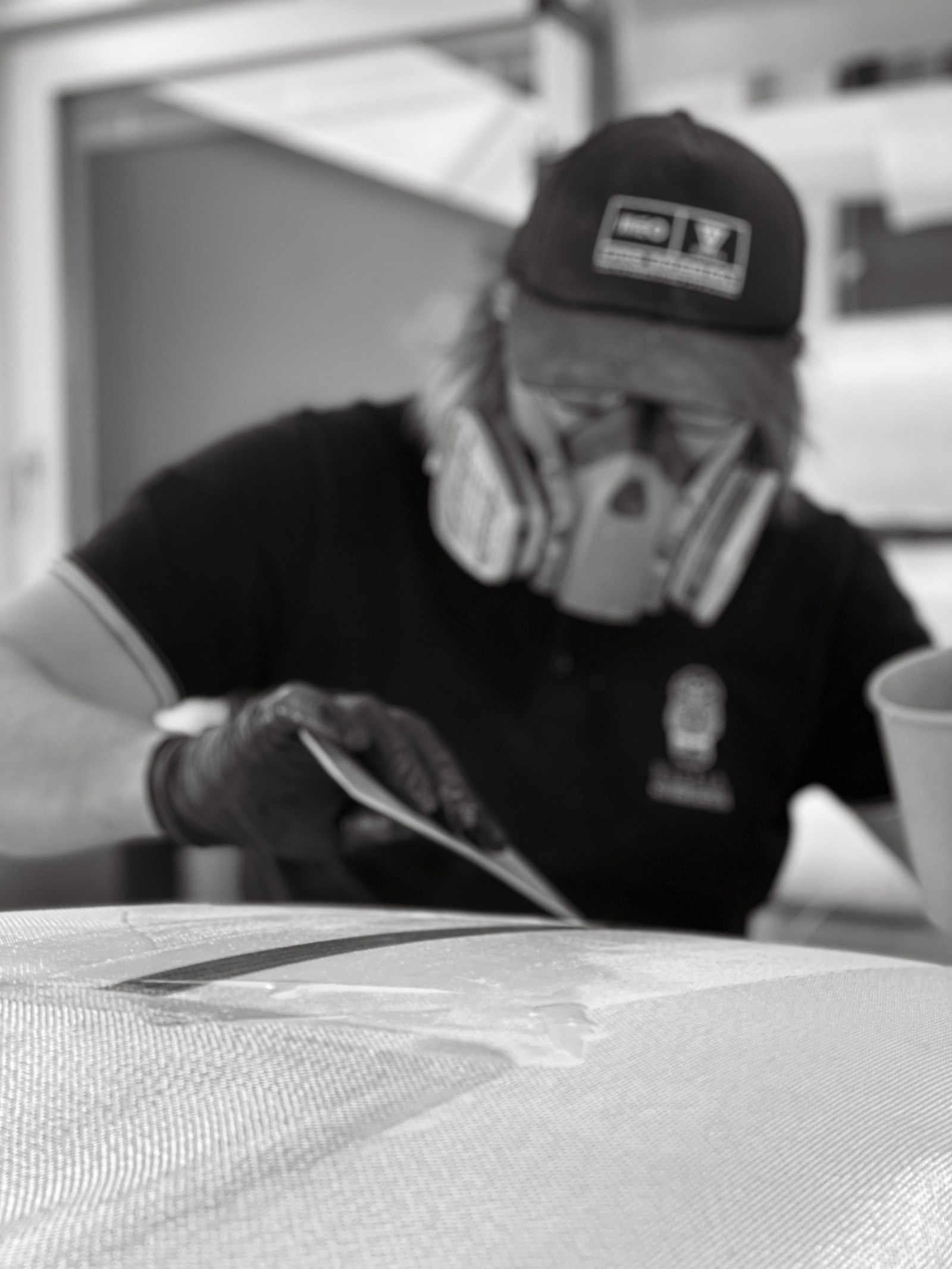 Shaper sanding a LIND board by hand in the workshop