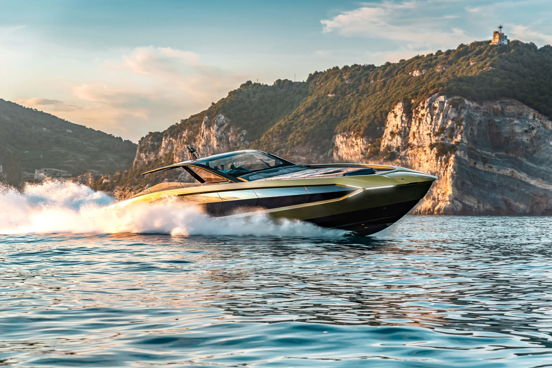 Tecnomar for Lamborghini 63 running at speed along a Mediterranean coastline