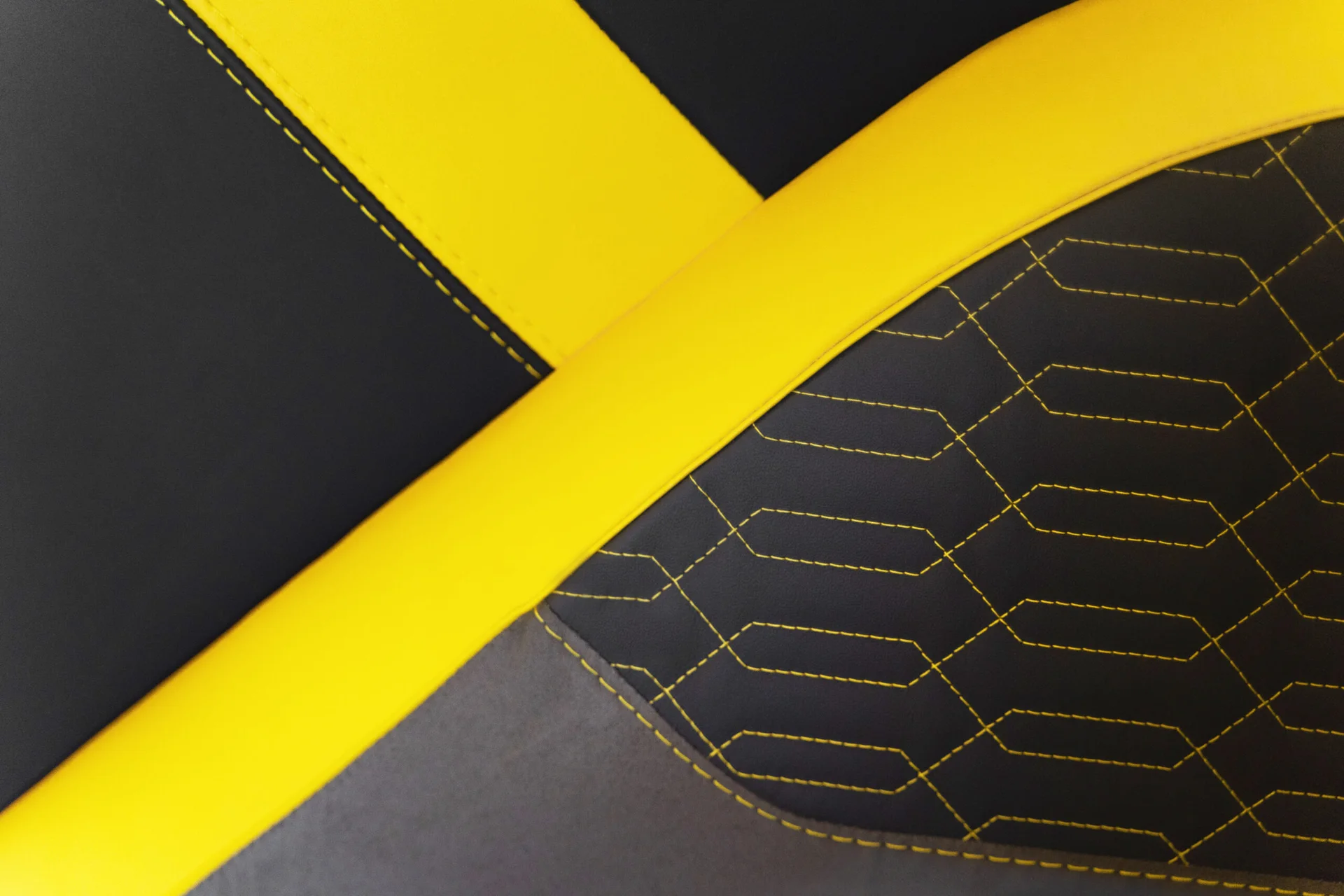 Y-shaped yellow stitching across dark upholstery aboard the yacht
