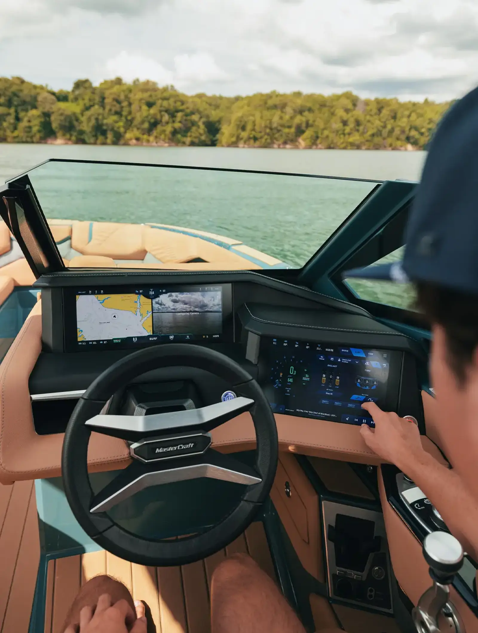 Driver at the wheel touching the screen of the 2026 X24
