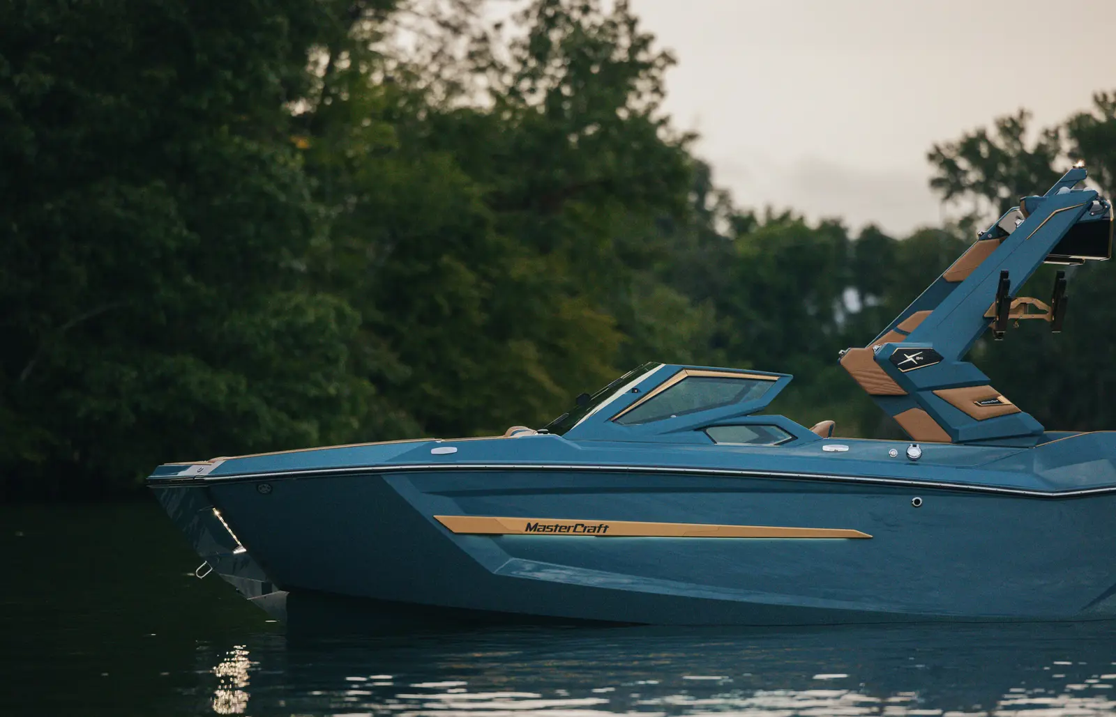 Profile view of the 2026 MasterCraft X24 sitting on calm water