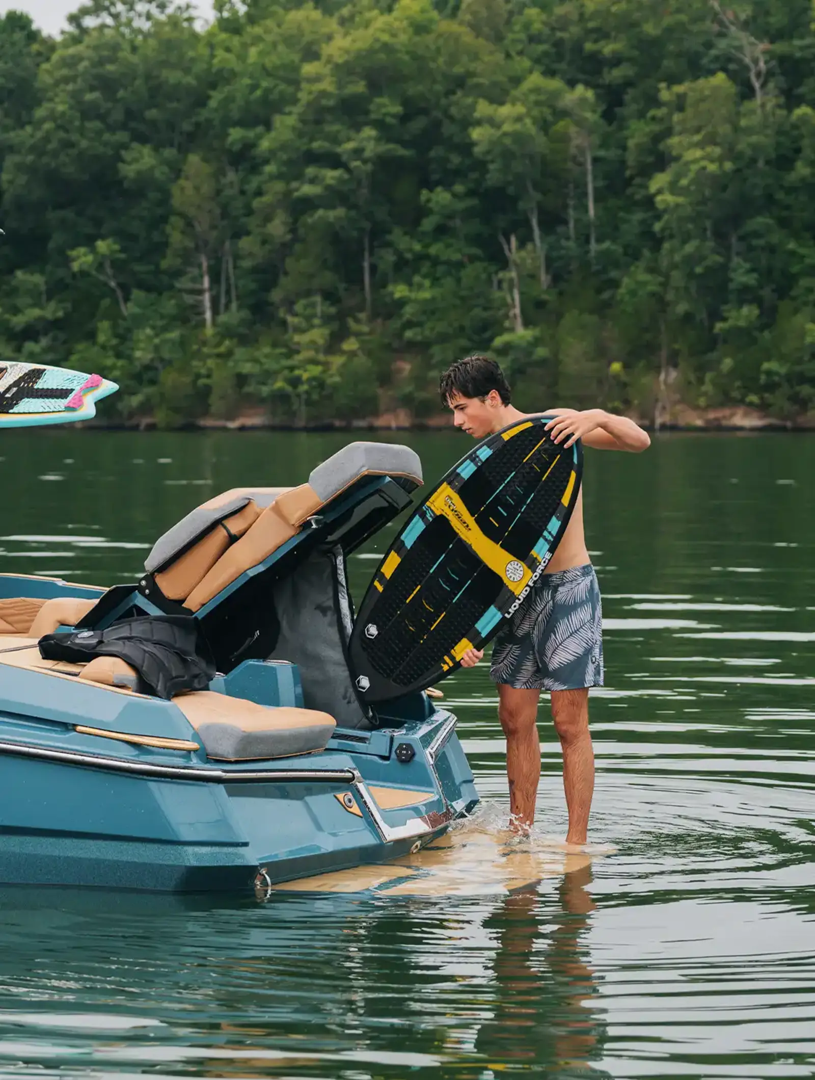 Dual rear transom storage compartments open on the X24