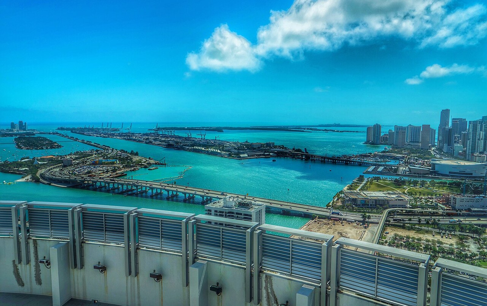 Center console boats lined along a Miami show dock with the skyline behind