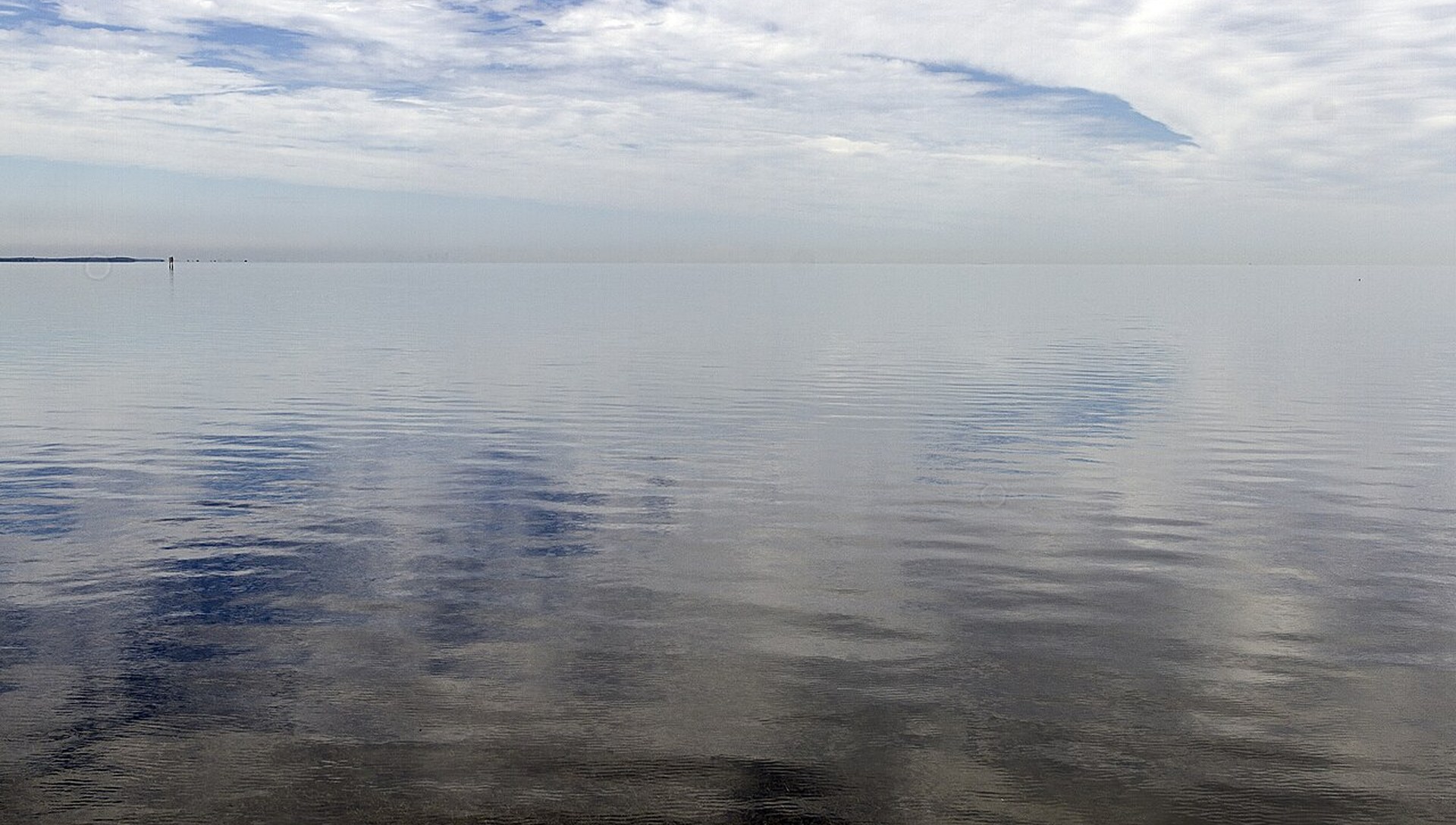 Calm open water on Biscayne Bay under a wide Florida sky