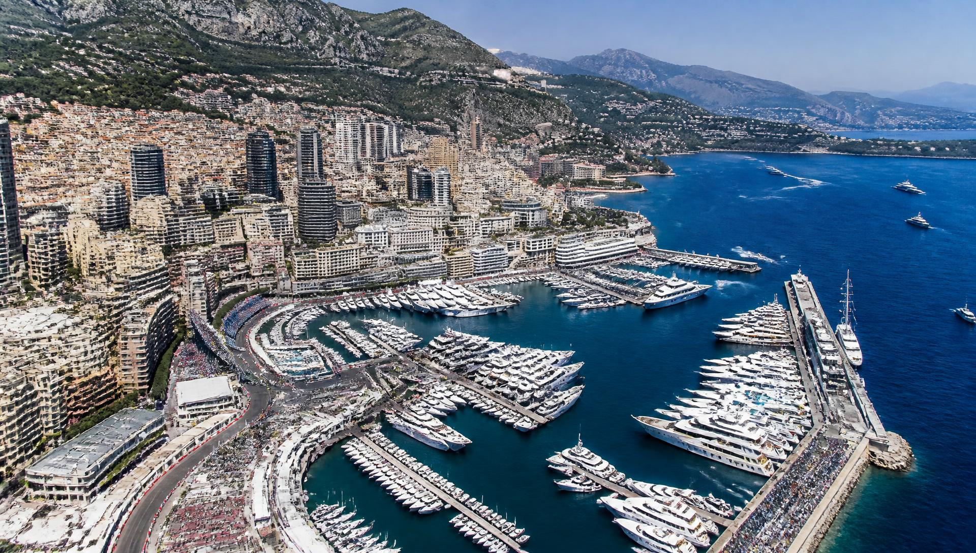 Superyachts filling Port Hercule in Monaco with Monte Carlo rising behind