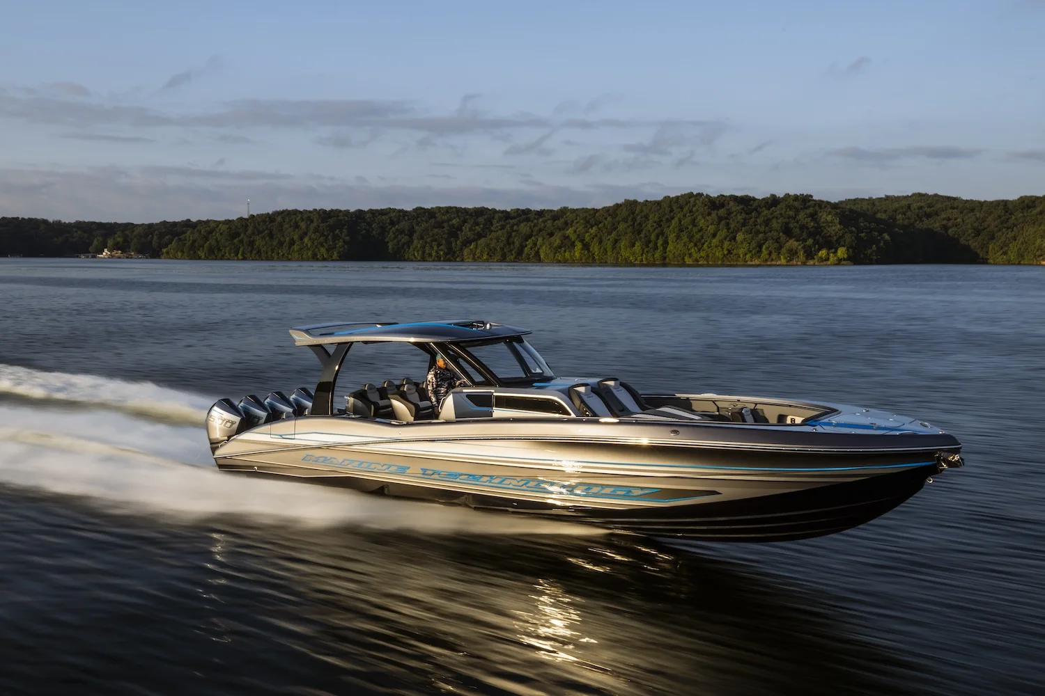 MTI performance boat cruising along a shoreline