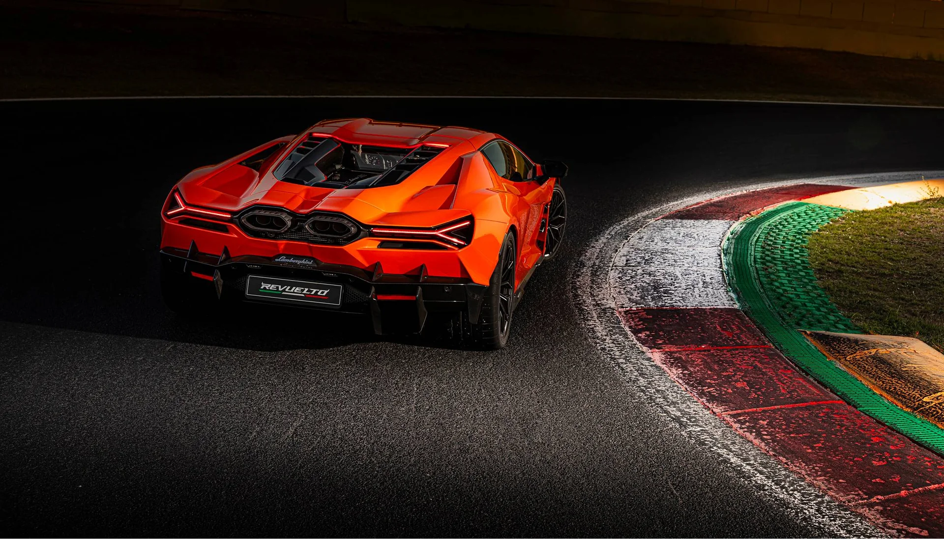 Lamborghini Revuelto from behind on a racetrack at night