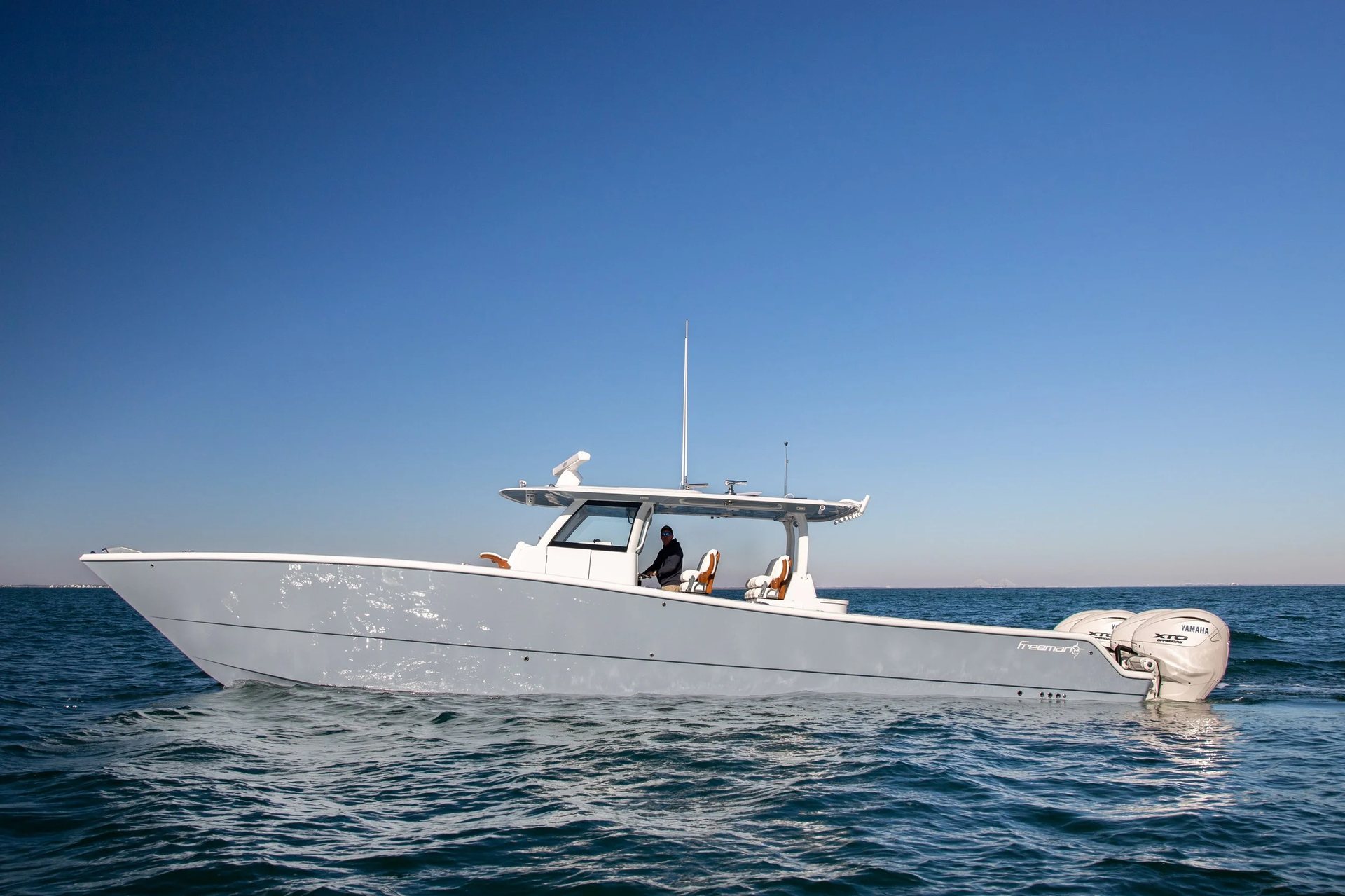Freeman catamaran running with its bank of outboards visible on the transom