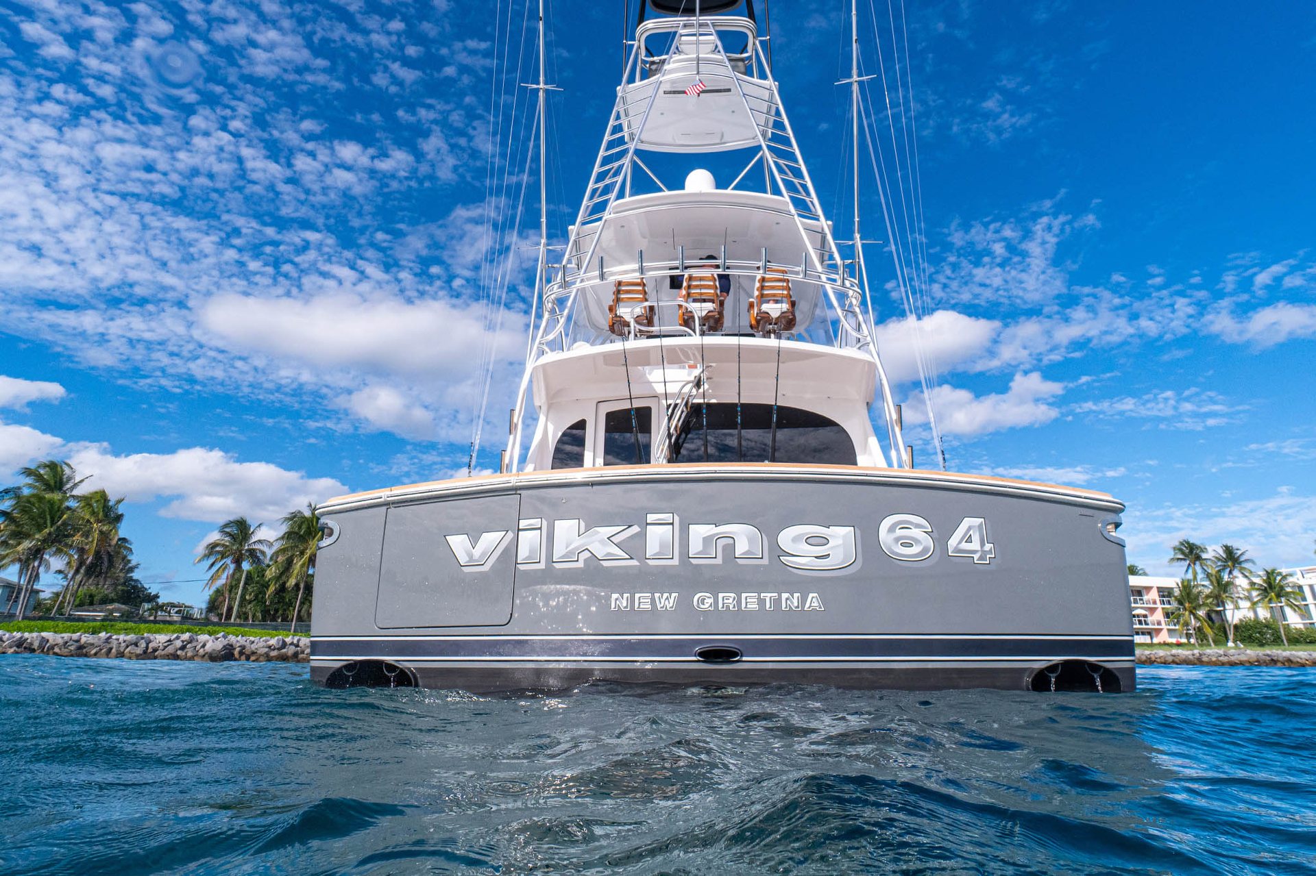 Sportfishing yacht idling into a marina at dusk