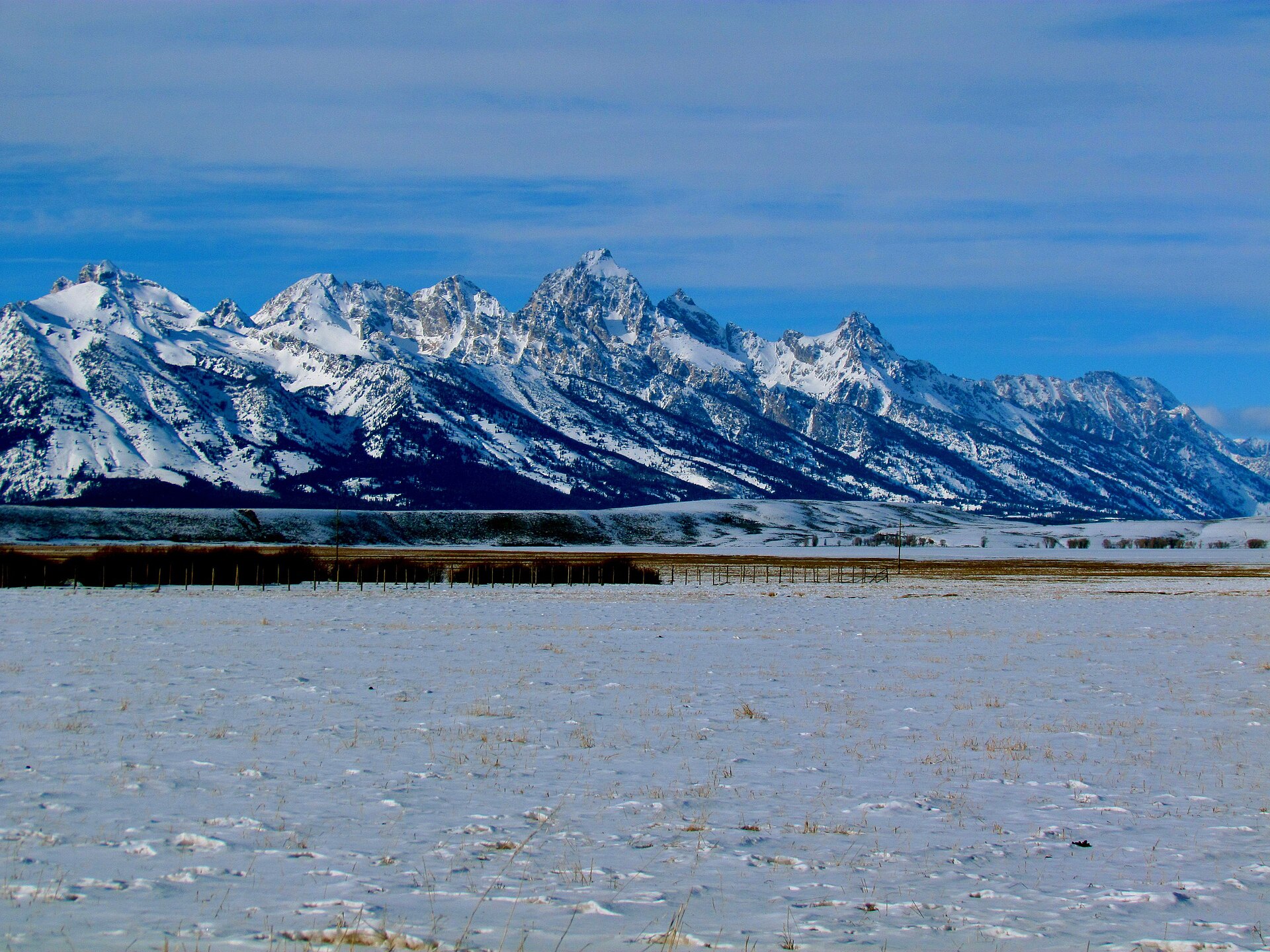The snow-covered Teton Range under a winter sky in Wyoming