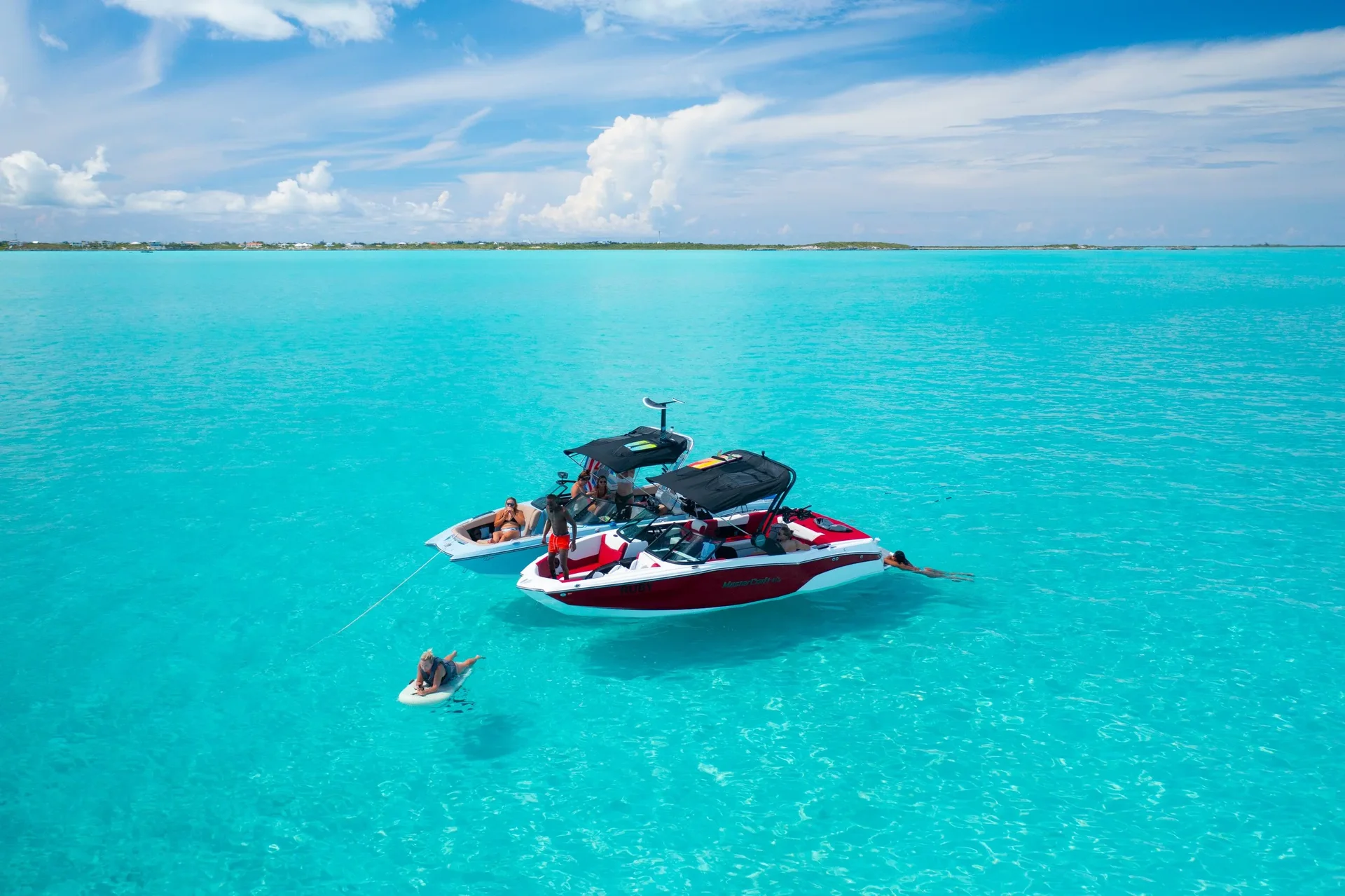Wake to Wake wakeboat sitting in bright turquoise water